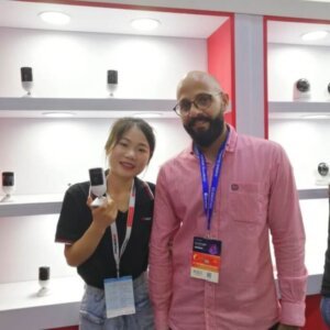 SNOSECURE sales representative with international buyer discussing solar security camera at trade show